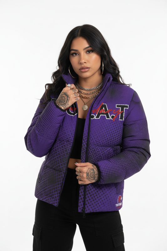 Young Hispanic female fashion designer with long hair, jewelry, and tattoos wearing zipped purple GOAT puffer jacket